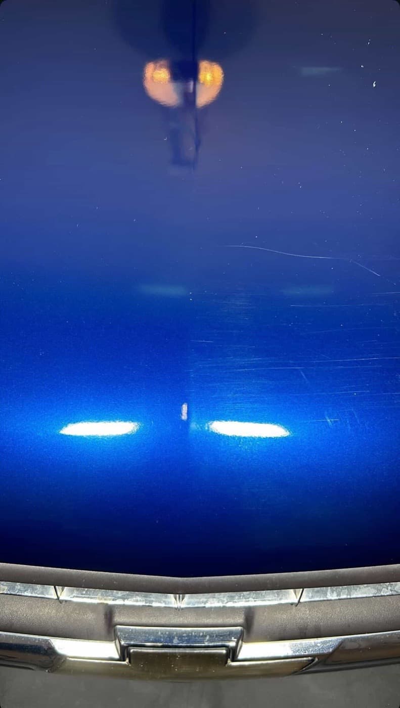 Blue truck hood with scratches before paint correction — Tucson AZ